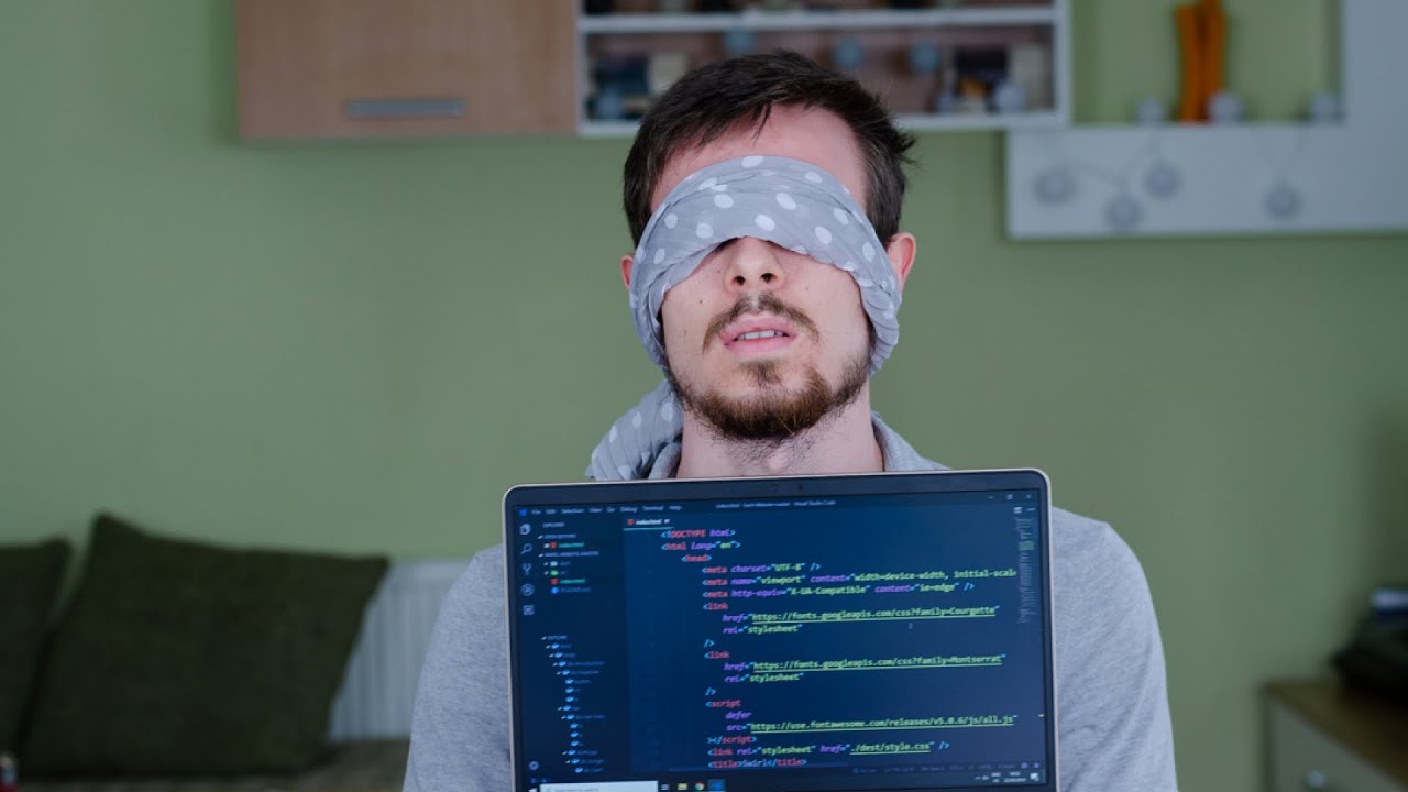 dude blindfolded behind a monitor with code on it